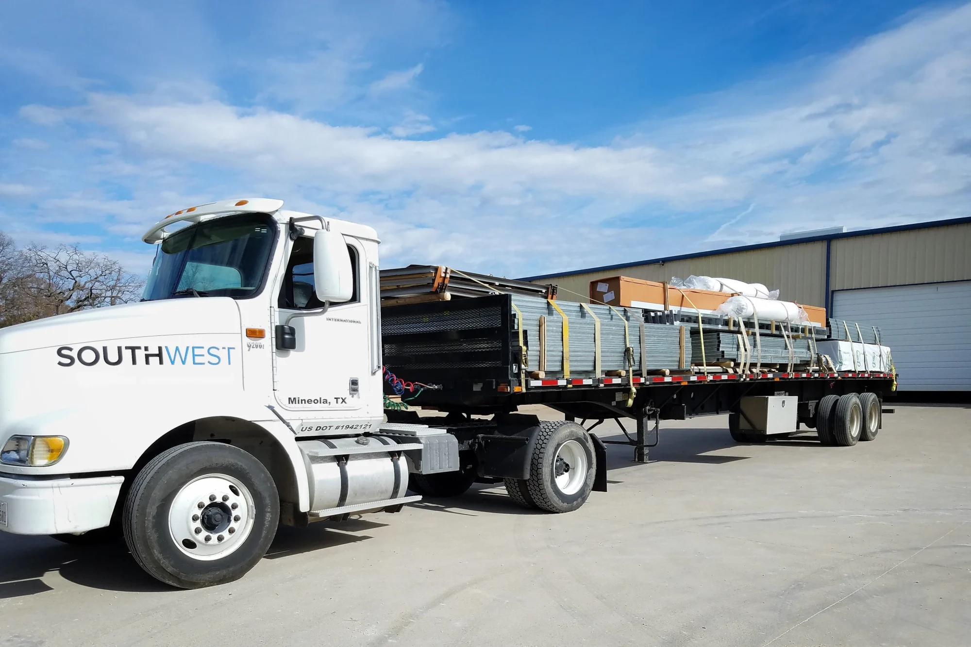 delivery truck loaded with steel building materials