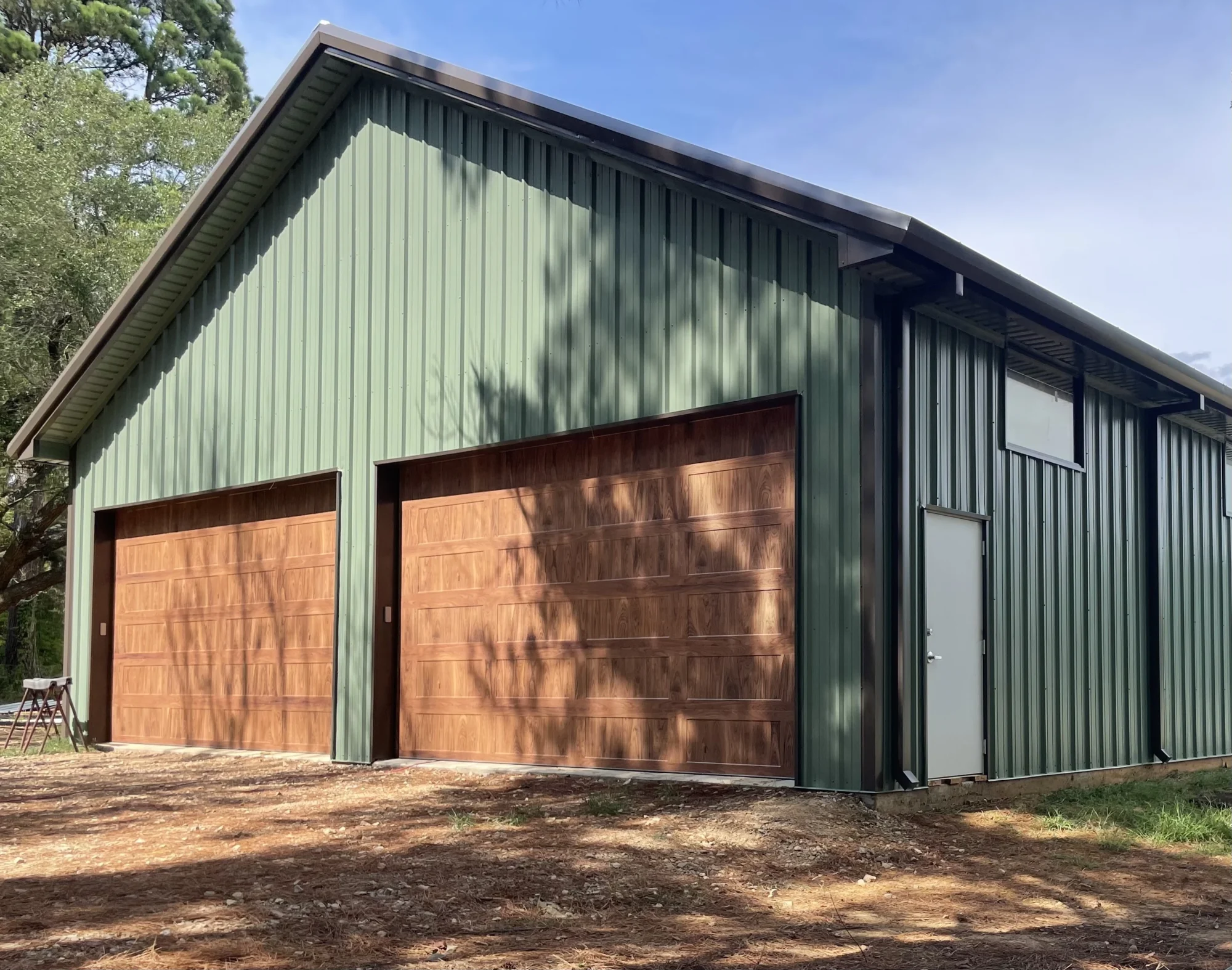 Green steel garage with wood finish doors