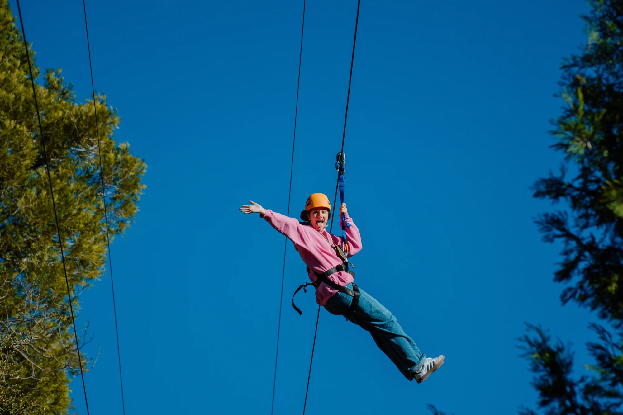 activities camper riding zipline arms spread excitement