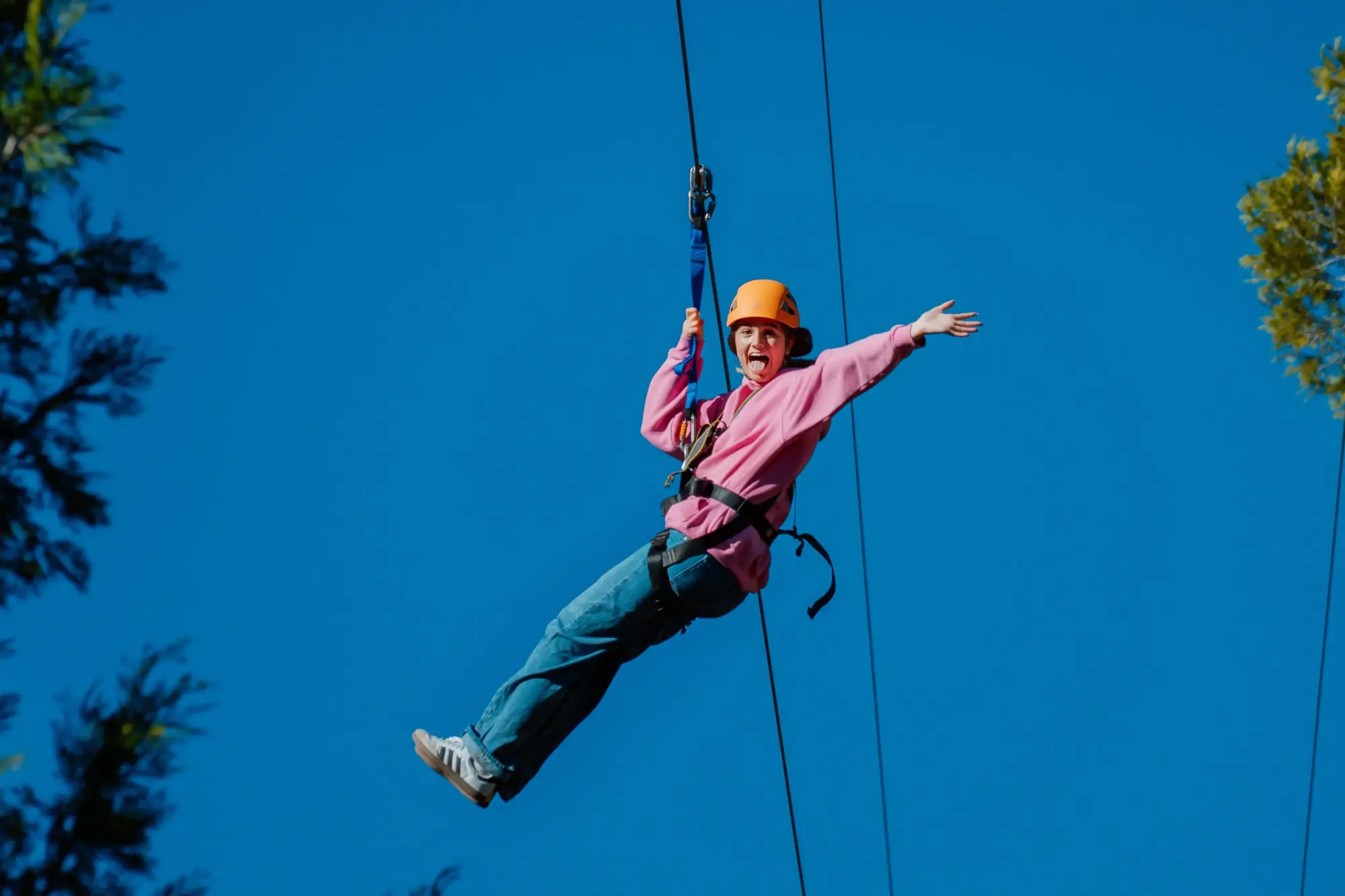 activities camper riding zipline arms spread excitement e2
