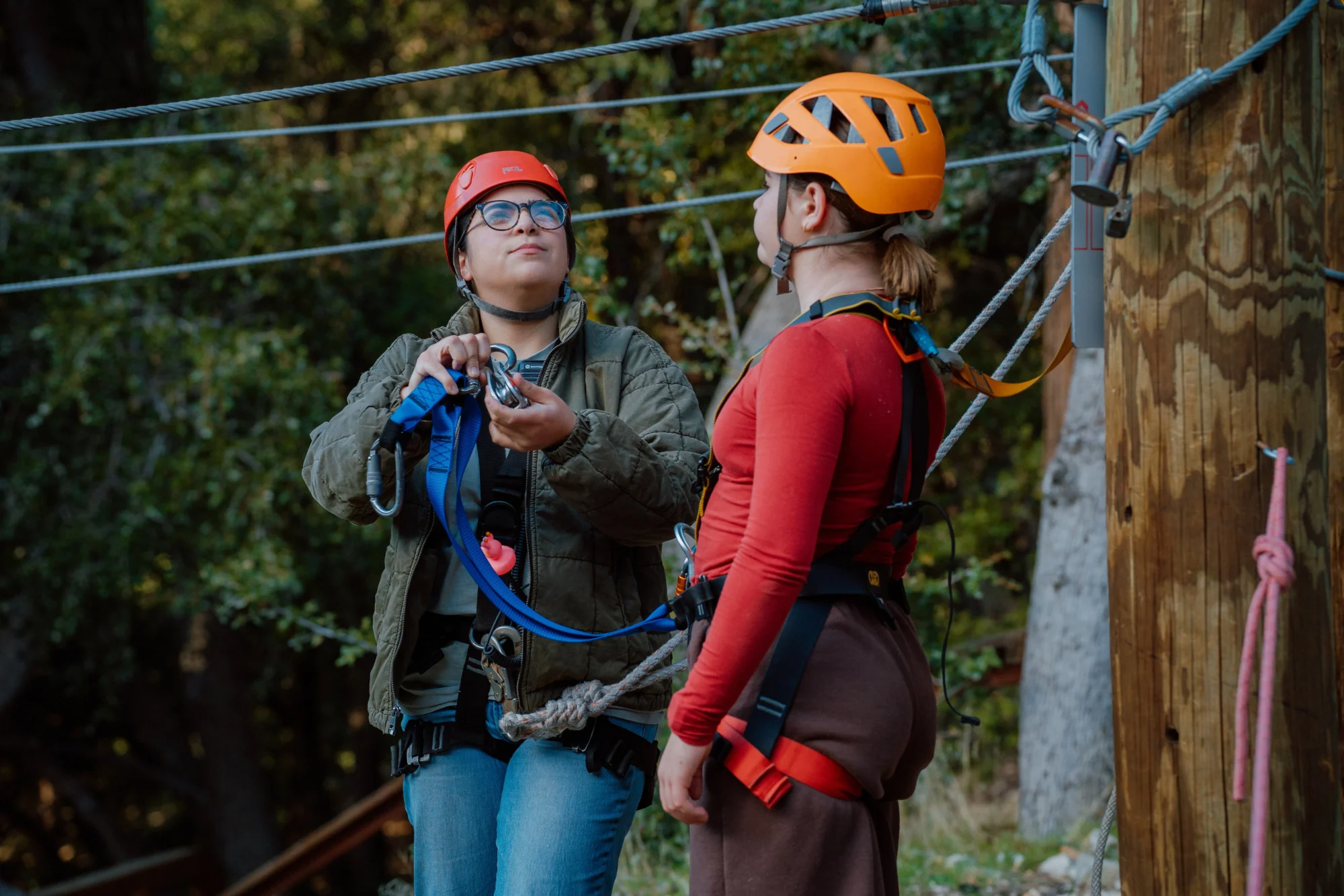 activities girl learning zipline equipment with instructor
