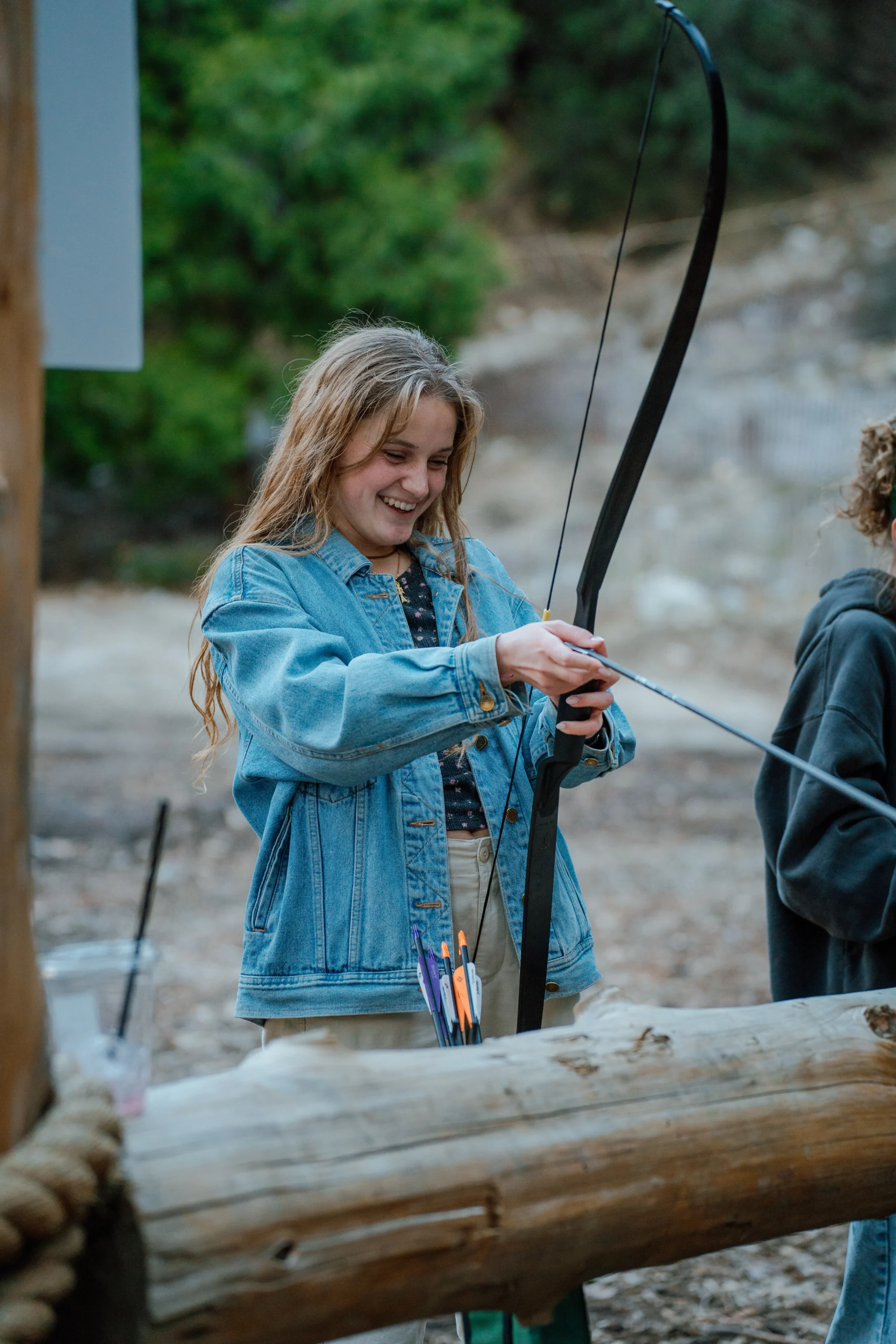 activities girl smiling at archery range