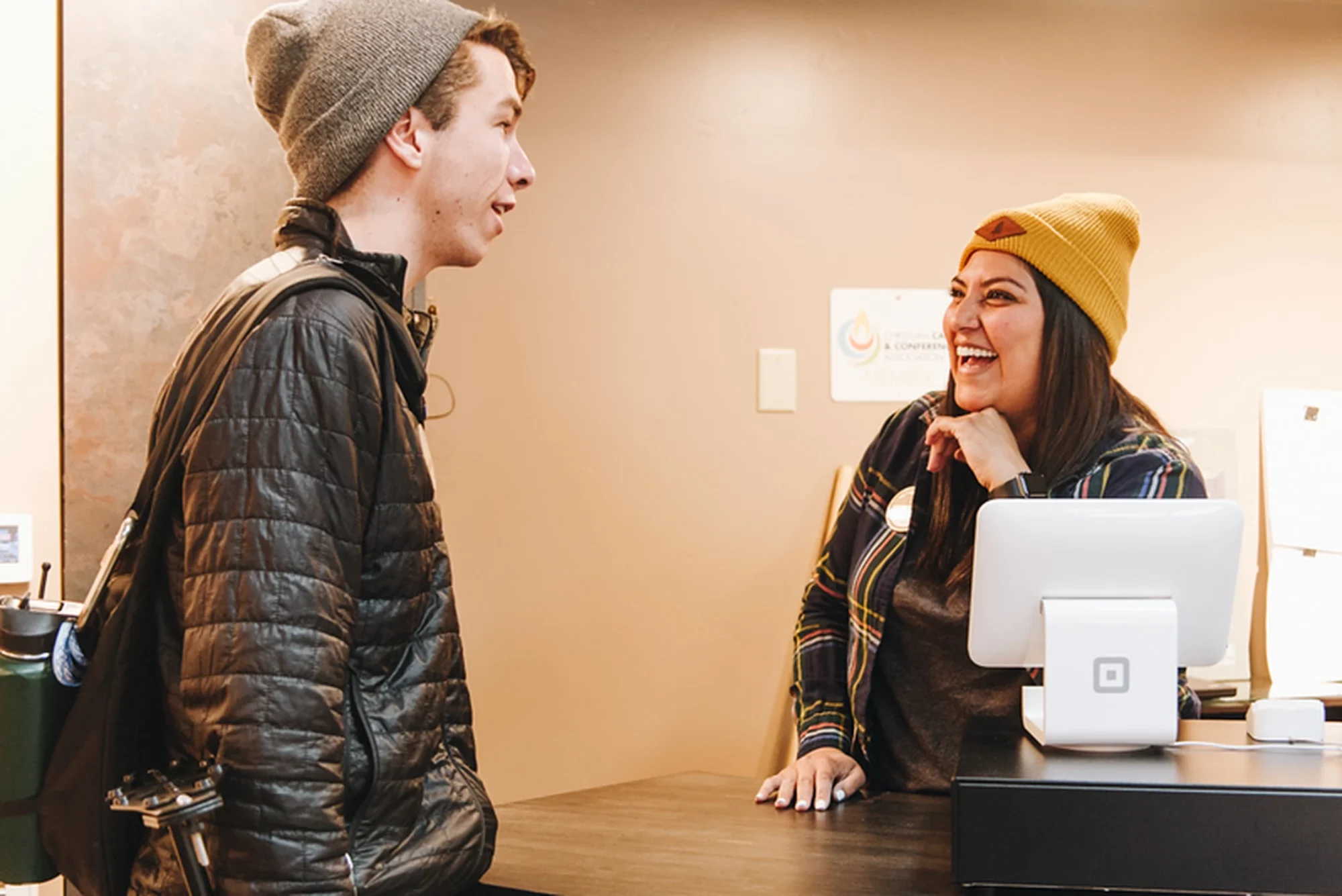 camp store staff serving customer register counter