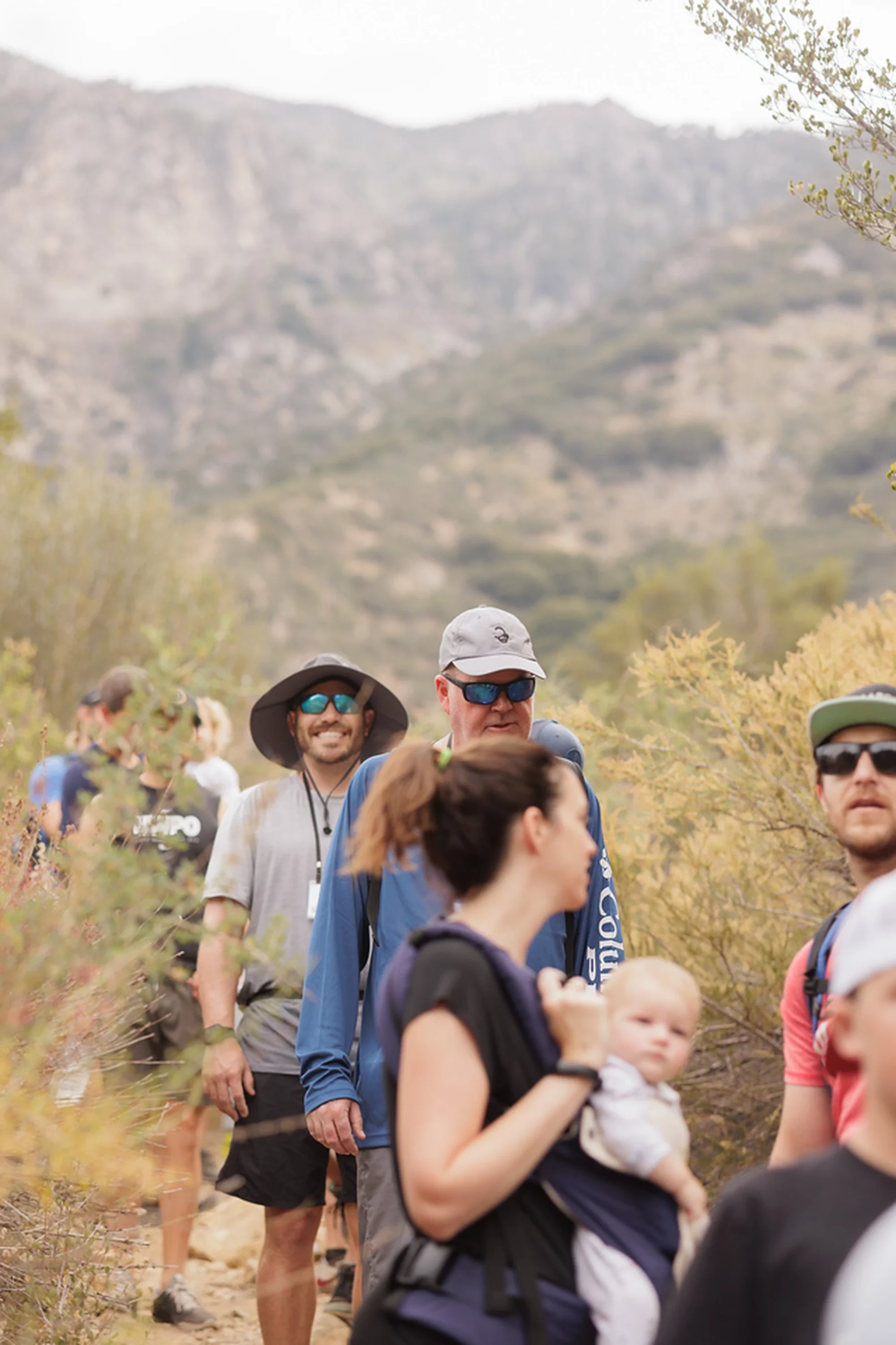 campers hiking group trek nature trail trees
