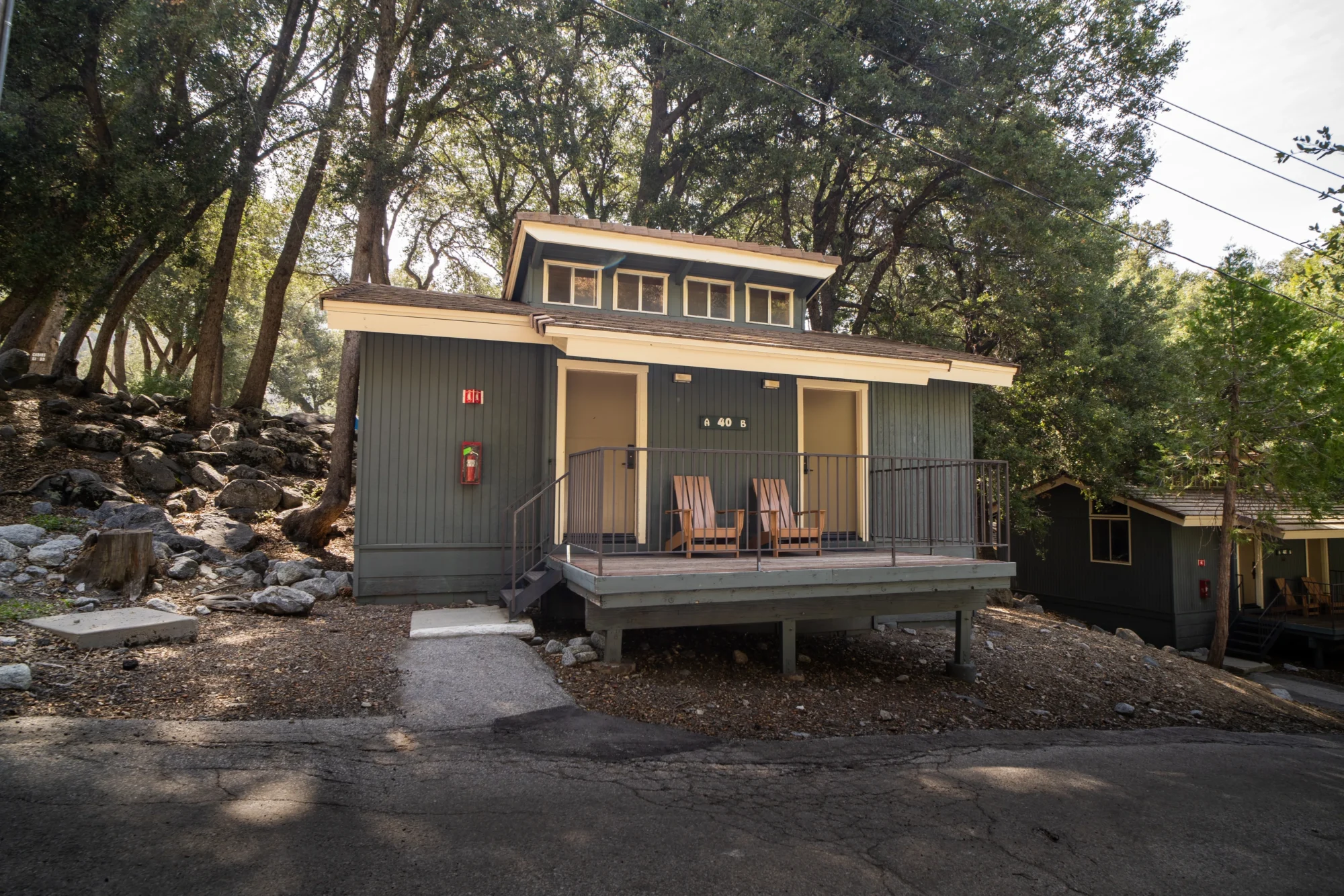 classic studio cabin exterior porch adirondack chairs