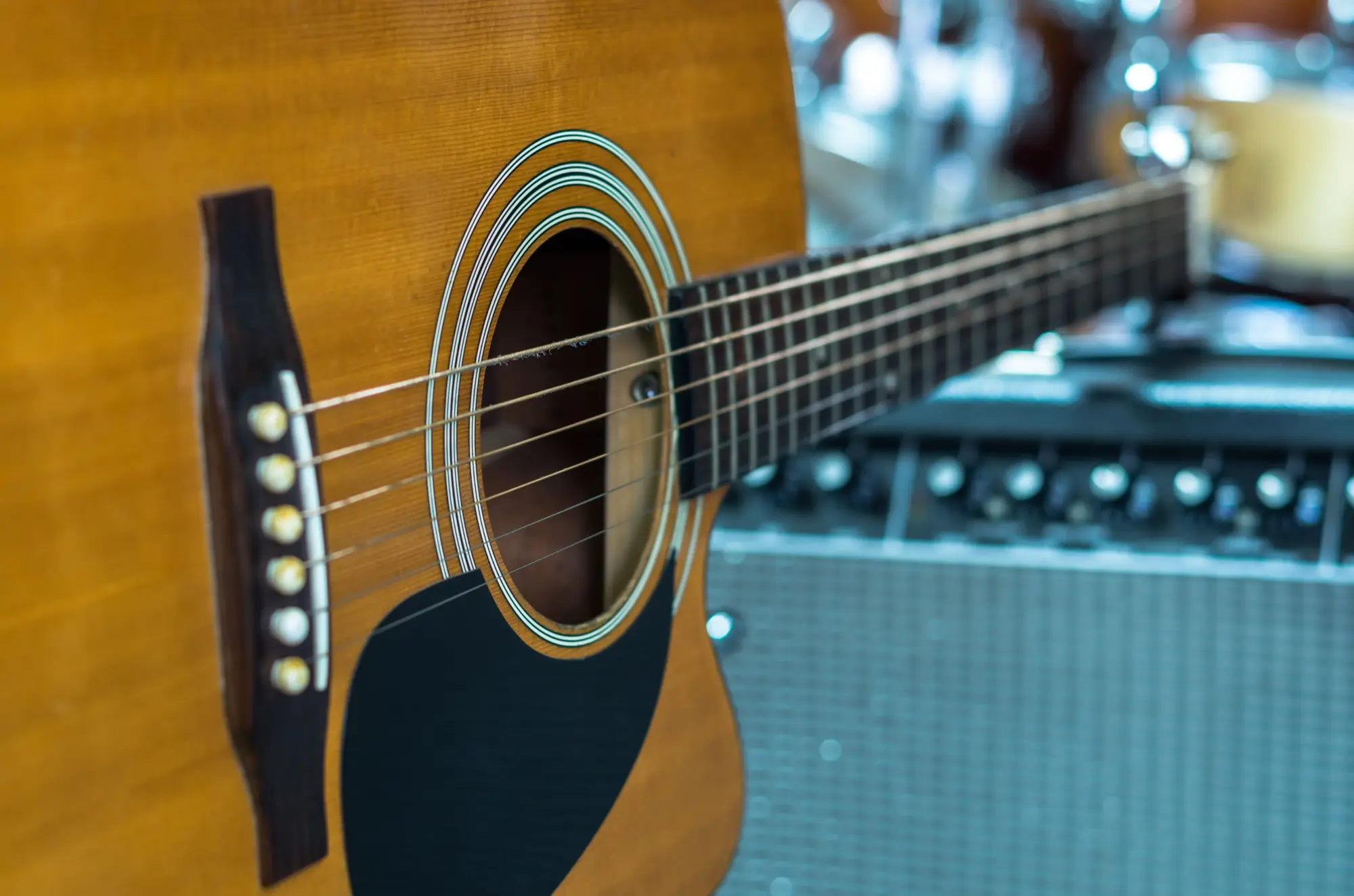 close up of acoustic guitar with amplifier 2026 03 10 02 02 18 utc