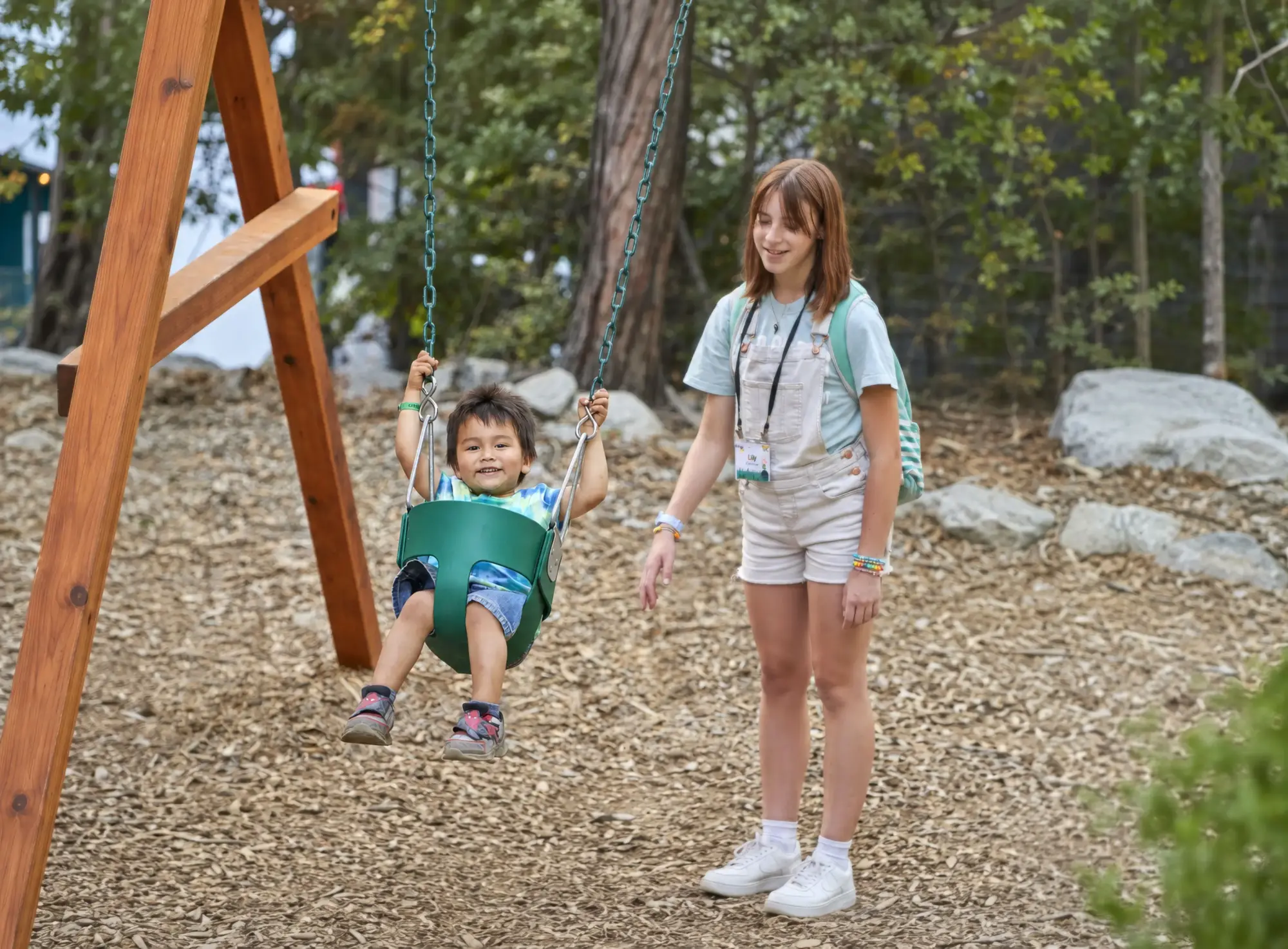 critter kids babysitter pushing boy bucket swing e4