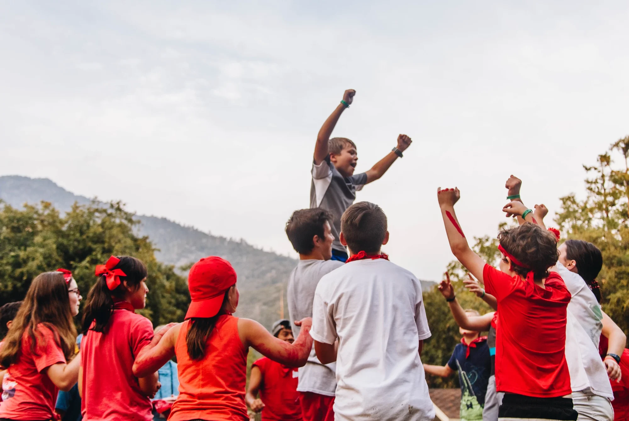 family camp basecamp red team kids fists raised victory celebration