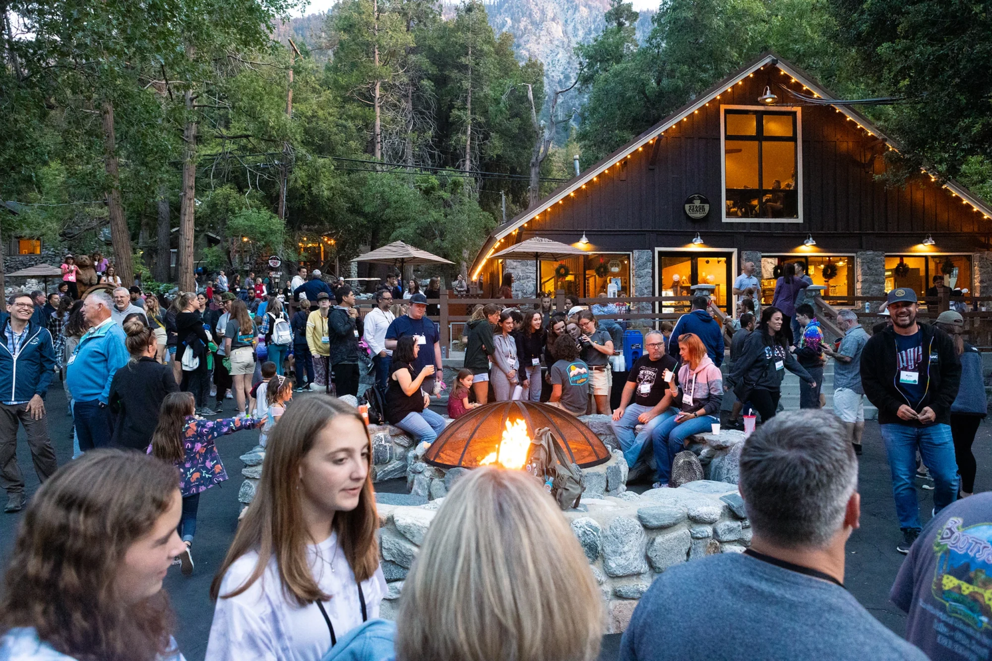 family camp evening campfire gathering families lodge outdoors