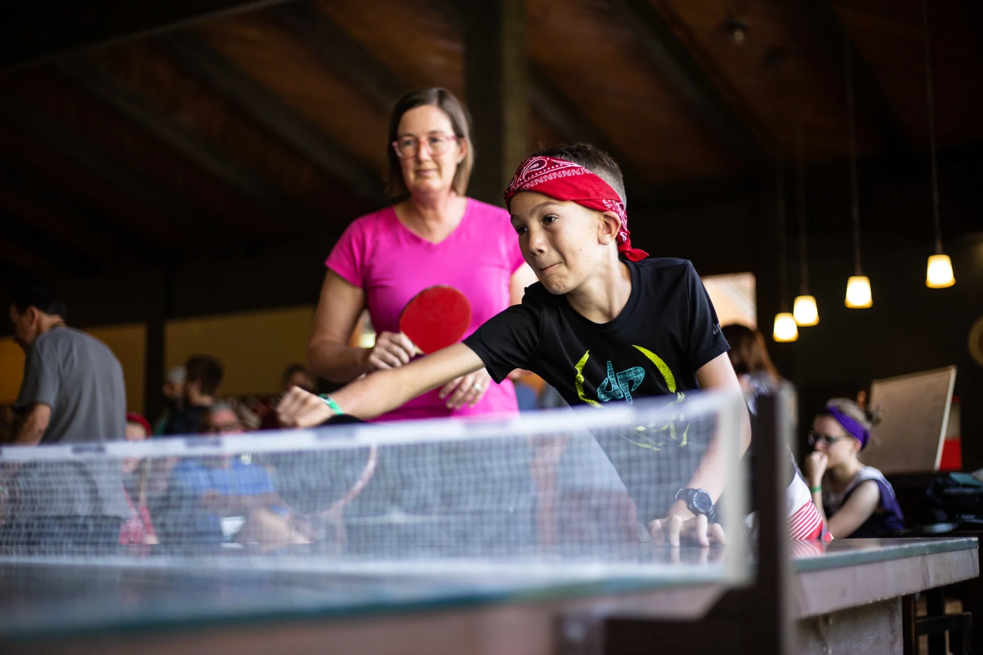 family camp game room boy playing ping pong