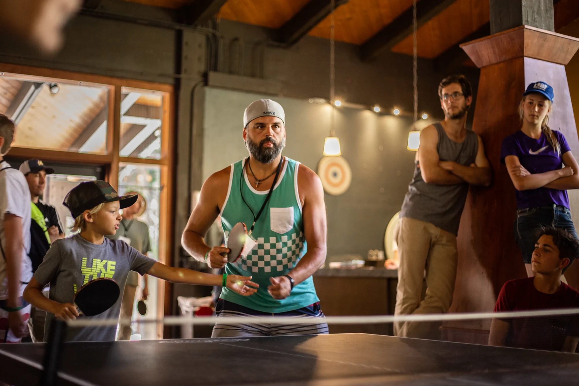 family camp game room dad playing ping pong tournament