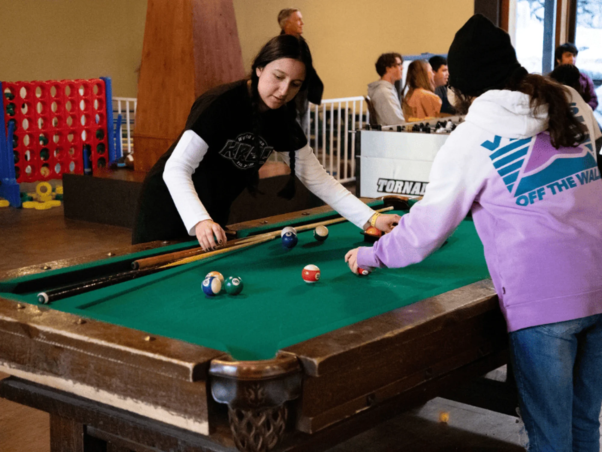 family camp game room teens playing pool billiards