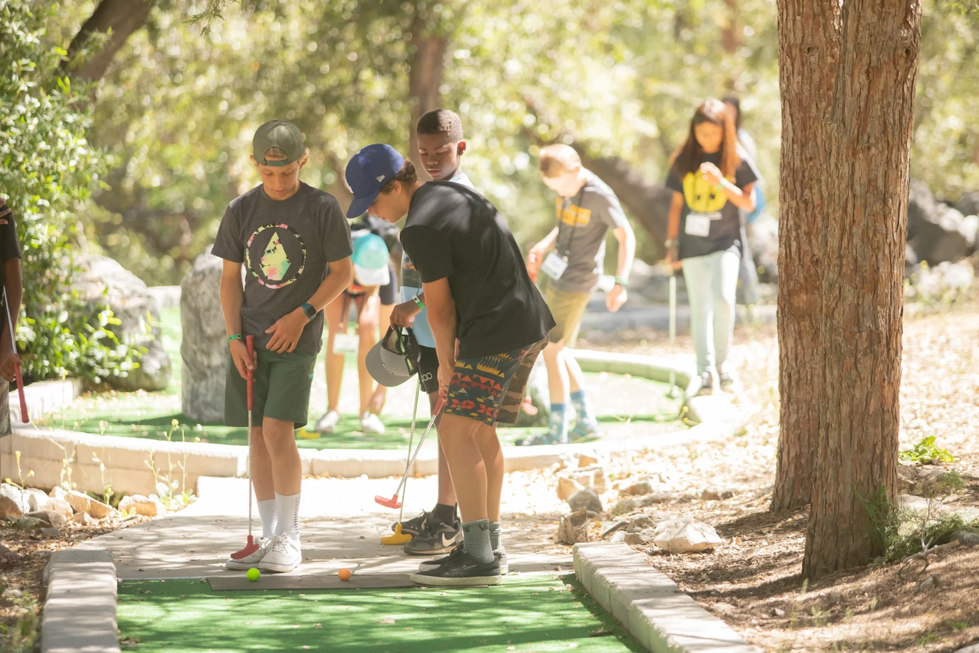 family camp mini golf teens group putting outdoor