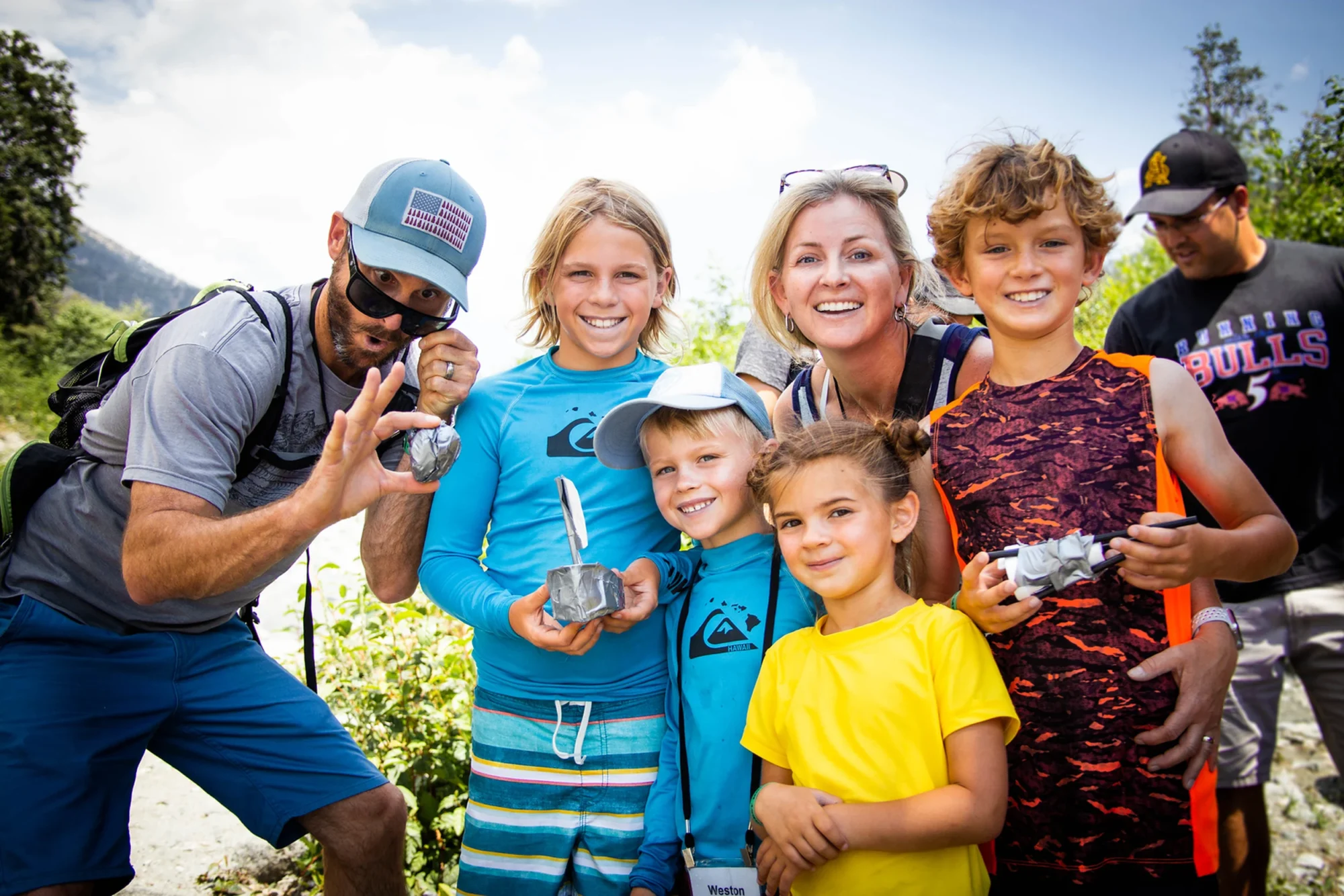 family camp parents kids smiling outdoor group portrait