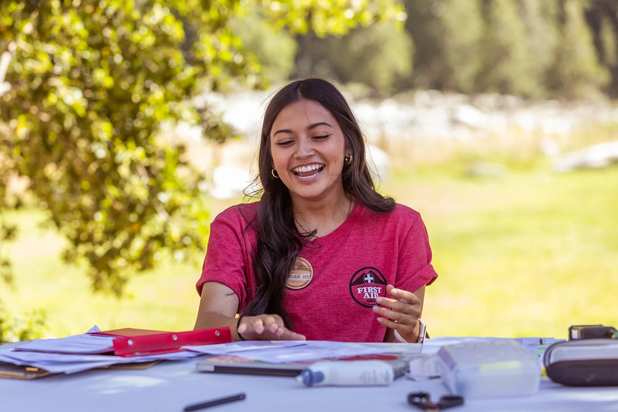 first aid staff smiling outdoor table supplies