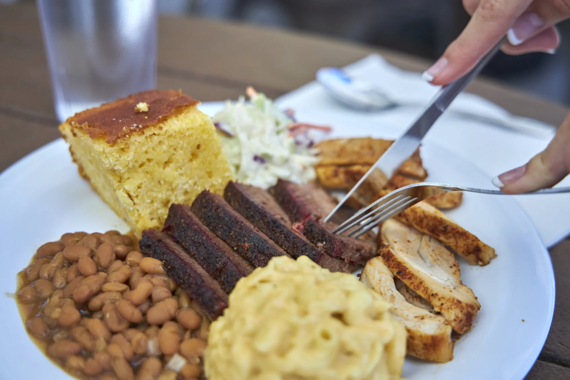food dining bbq plate brisket chicken cornbread beans coleslaw