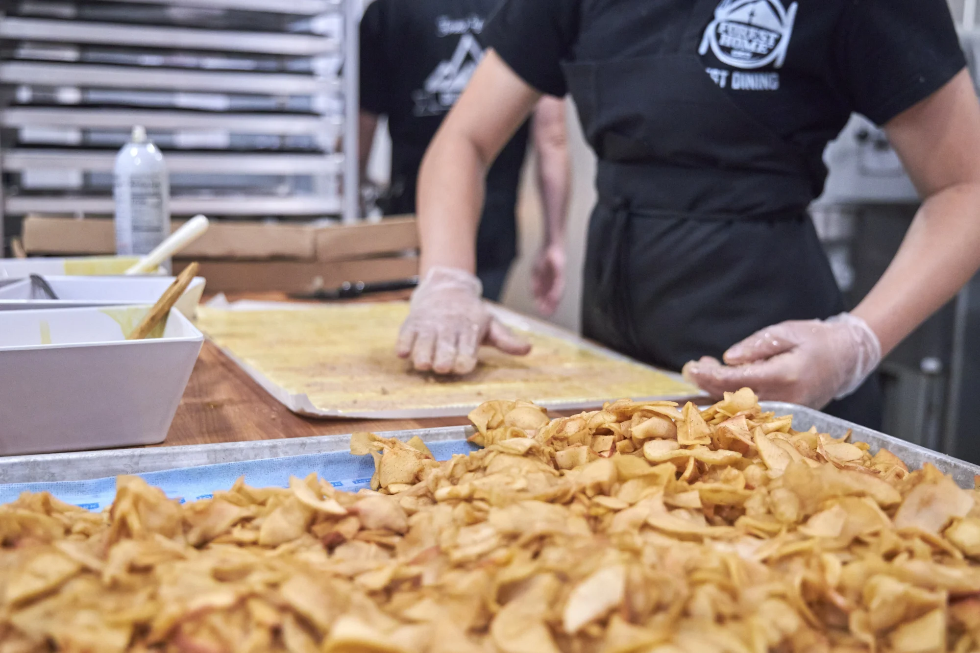 food dining camp kitchen staff preparing nachos on sheet trays