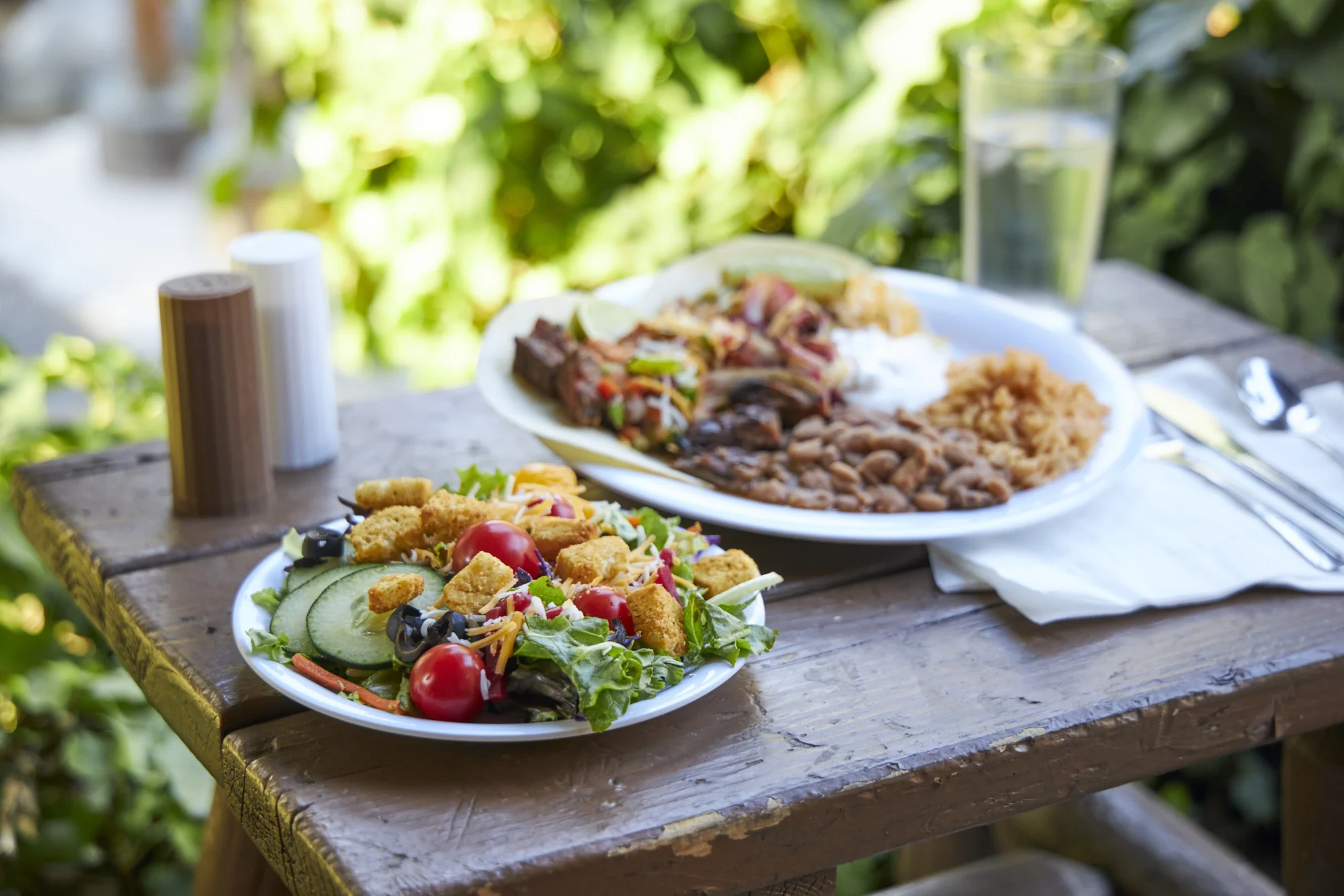 food dining fresh garden salad and steak rice beans outdoor camp table