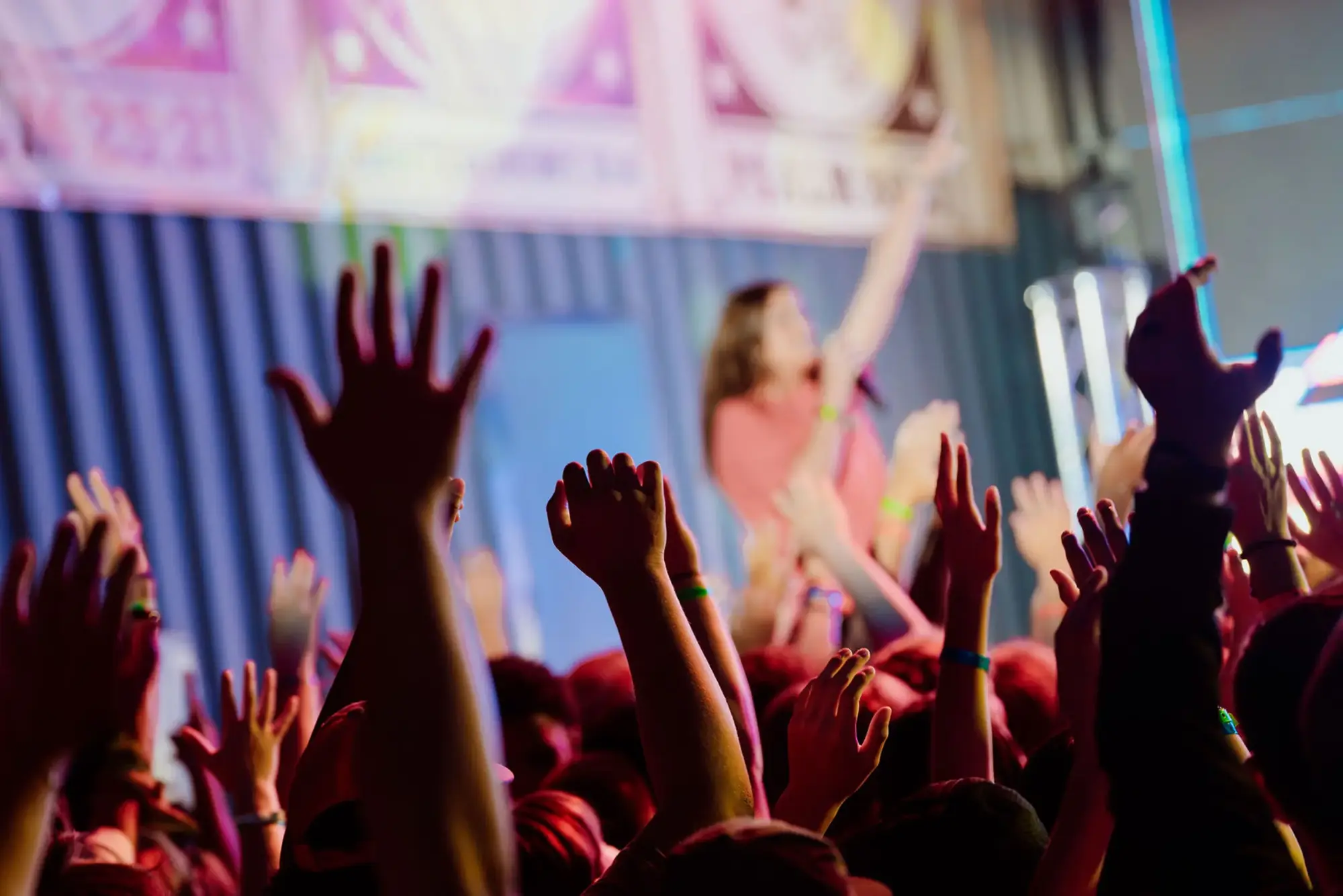 hands raised worship youth