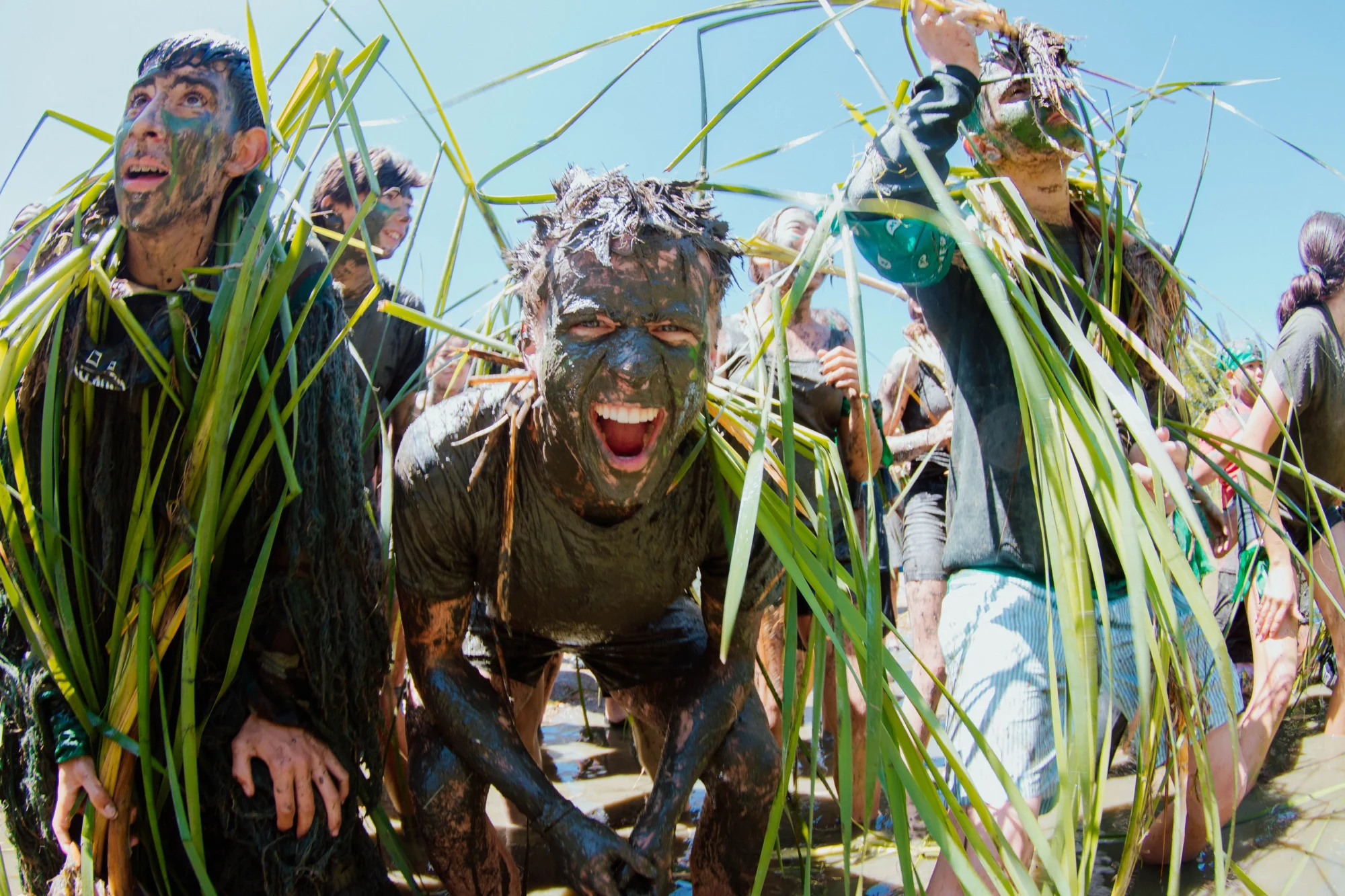 middle school campers mud covered faces screaming excitement
