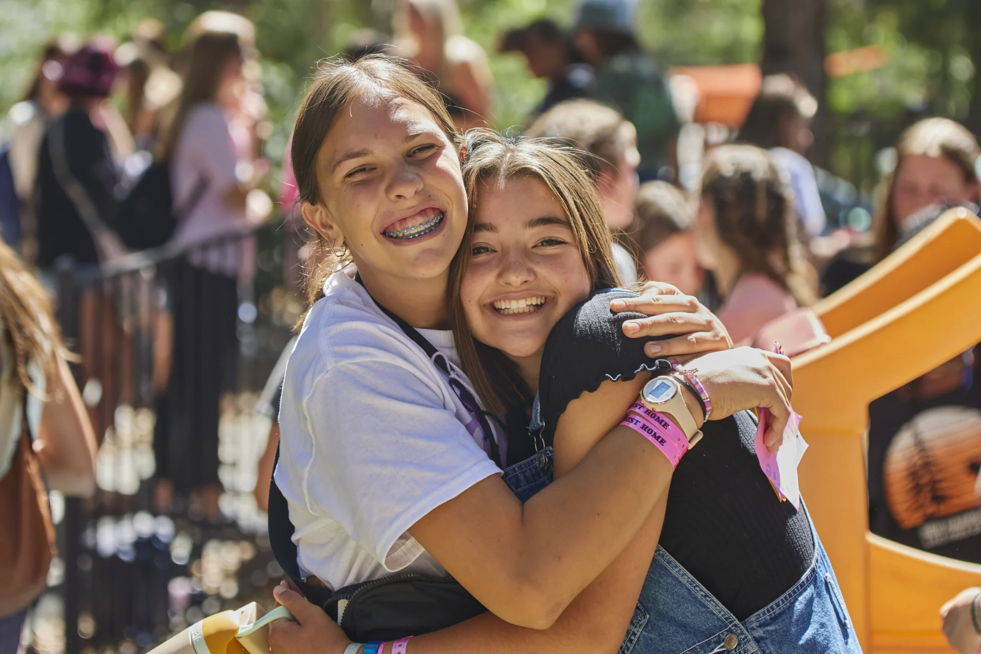 radiant friends hugging outdoor camp portrait