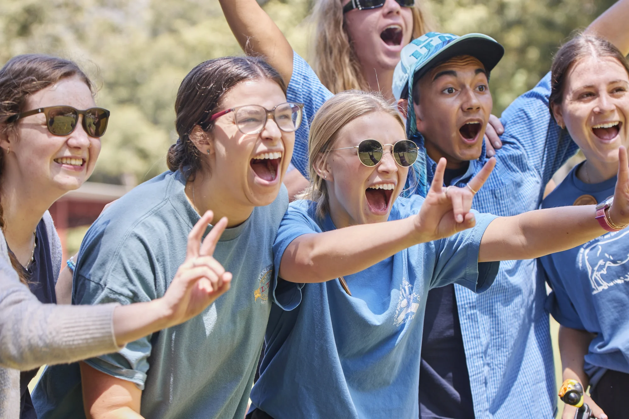 summer staff summer staff group excited poses blue shirts