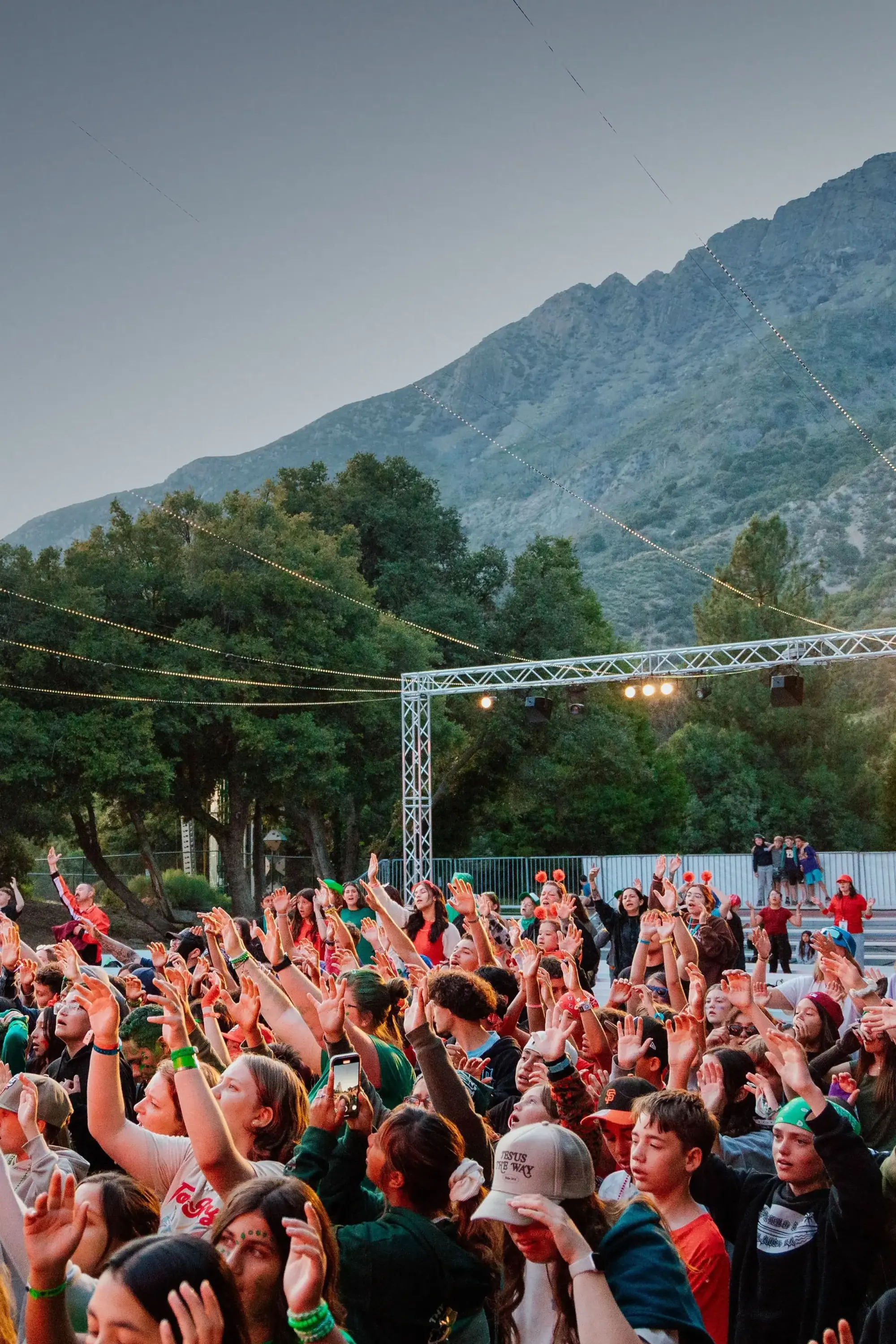 summer youth camp outdoor worship crowd mountain backdrop tall