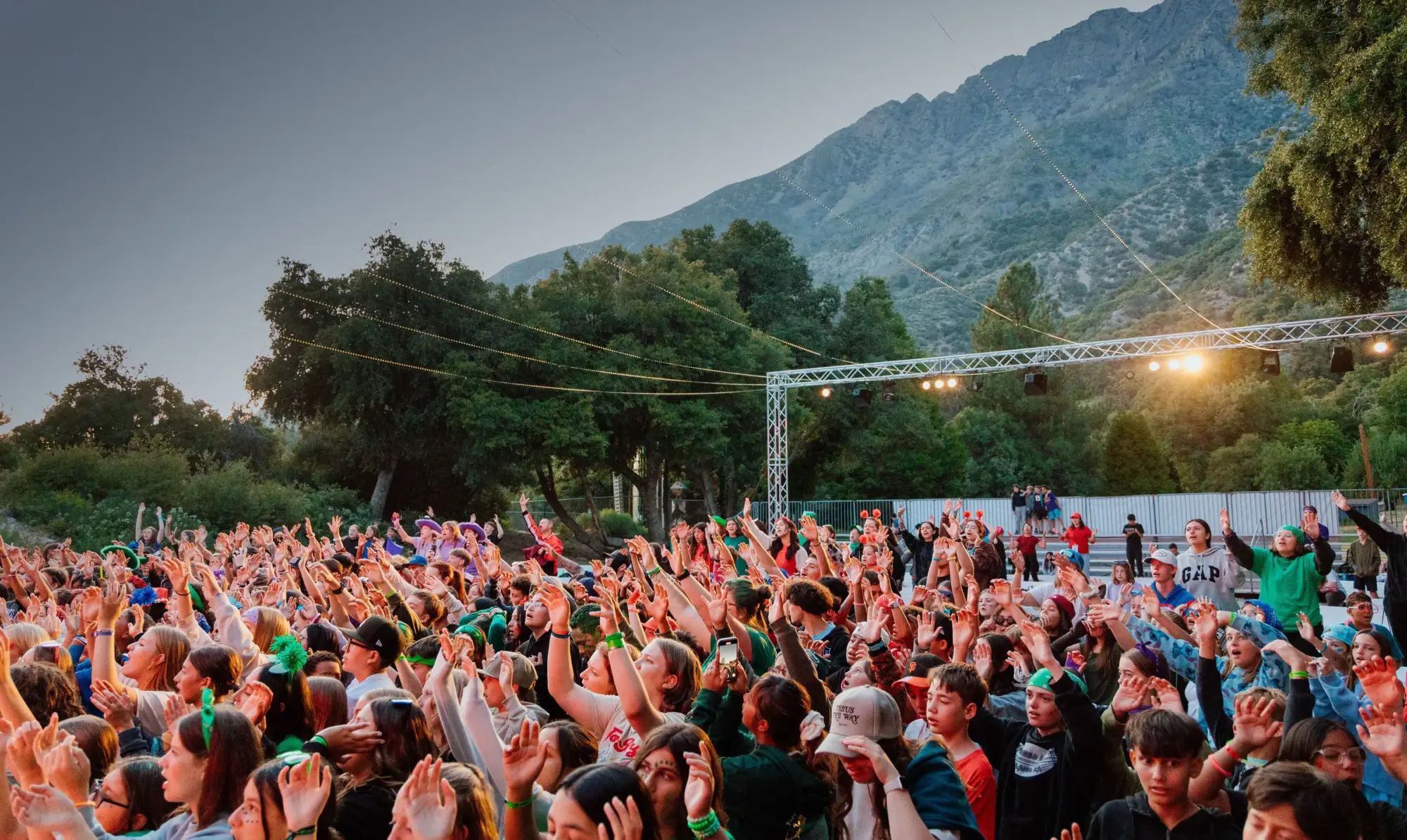 summer youth camp outdoor worship crowd mountain backdrop wide