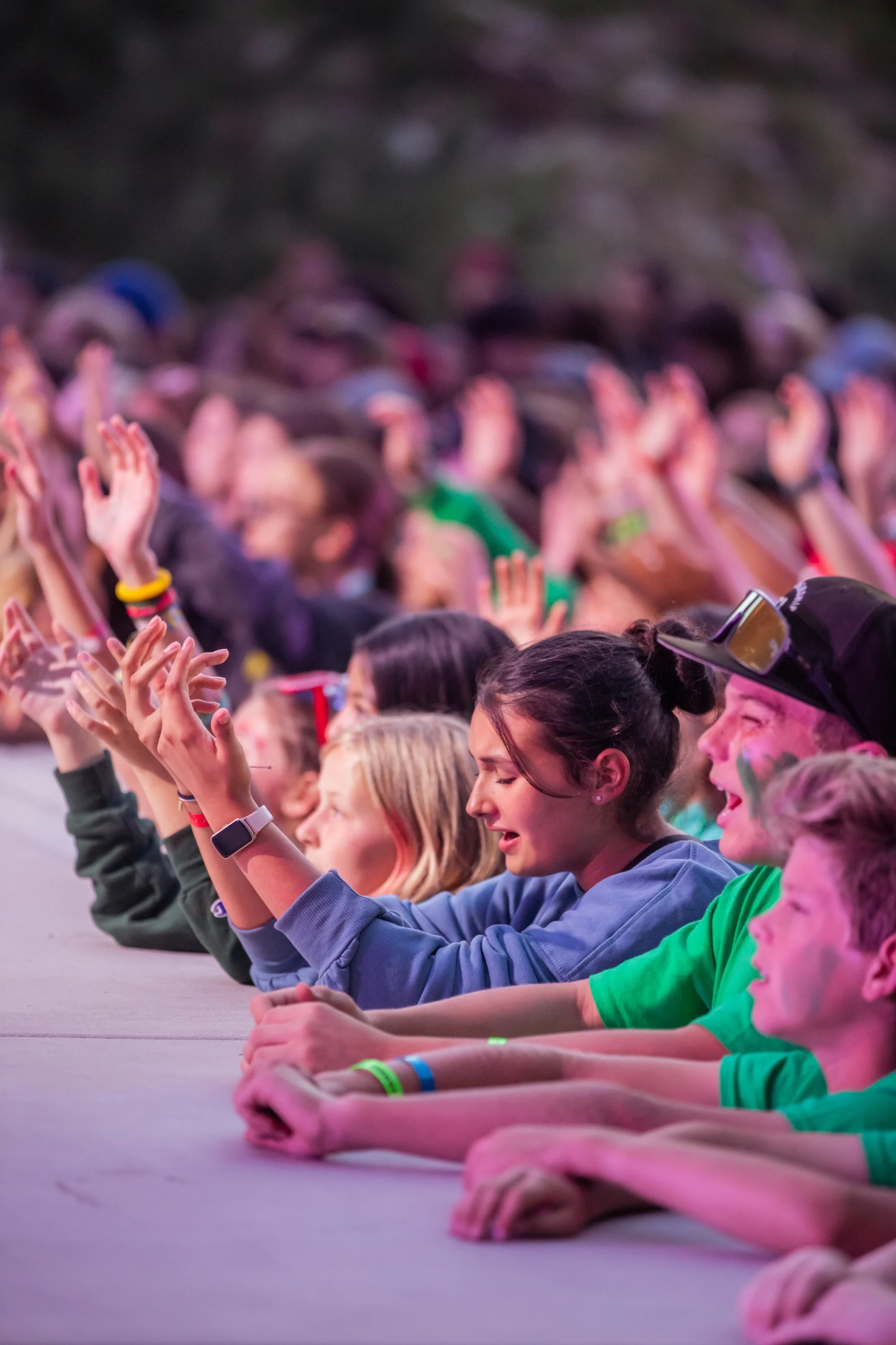 summer youth camp worship night crowd hands raised