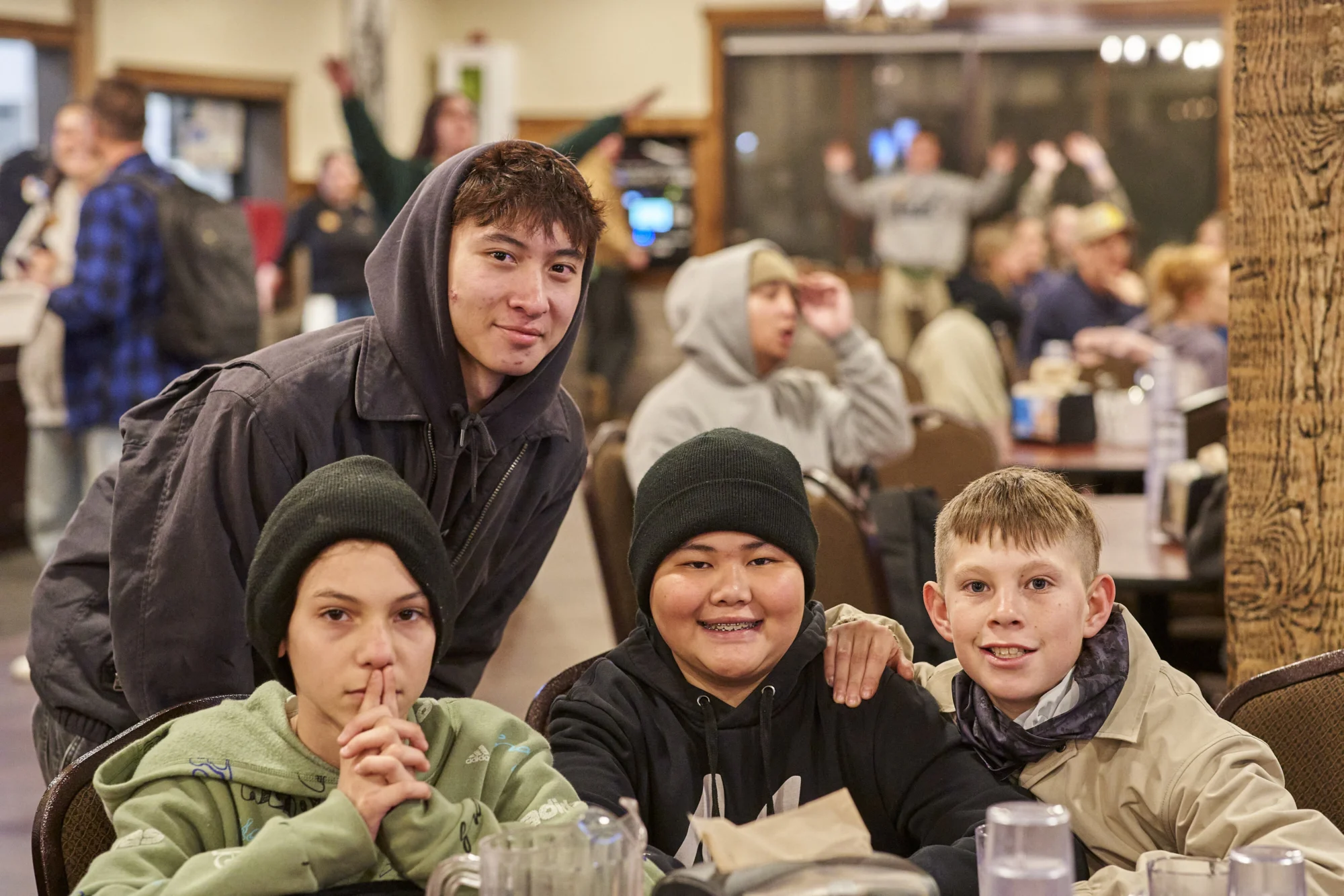 winter camp youth four boys posing together in dining hall